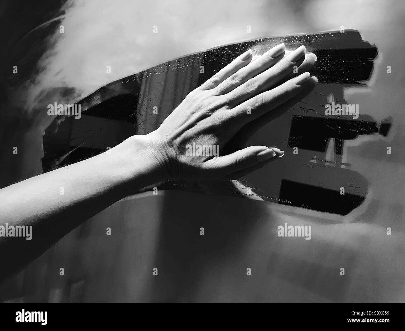Hand wiping a mirror at bathroom - Smartphone Captured Stock Image