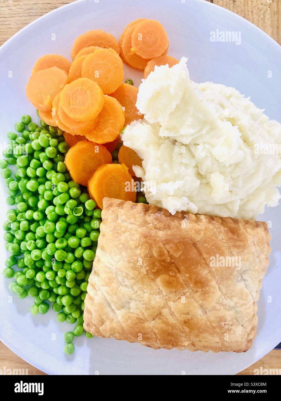 Steak pastry with mashed potatoes, carrots and peas Stock Photo Alamy