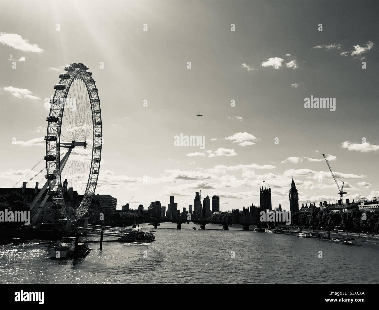 The London Eye by the River Thames and Big Ben in black and white on a clear day - Smartphone Captured Stock Image