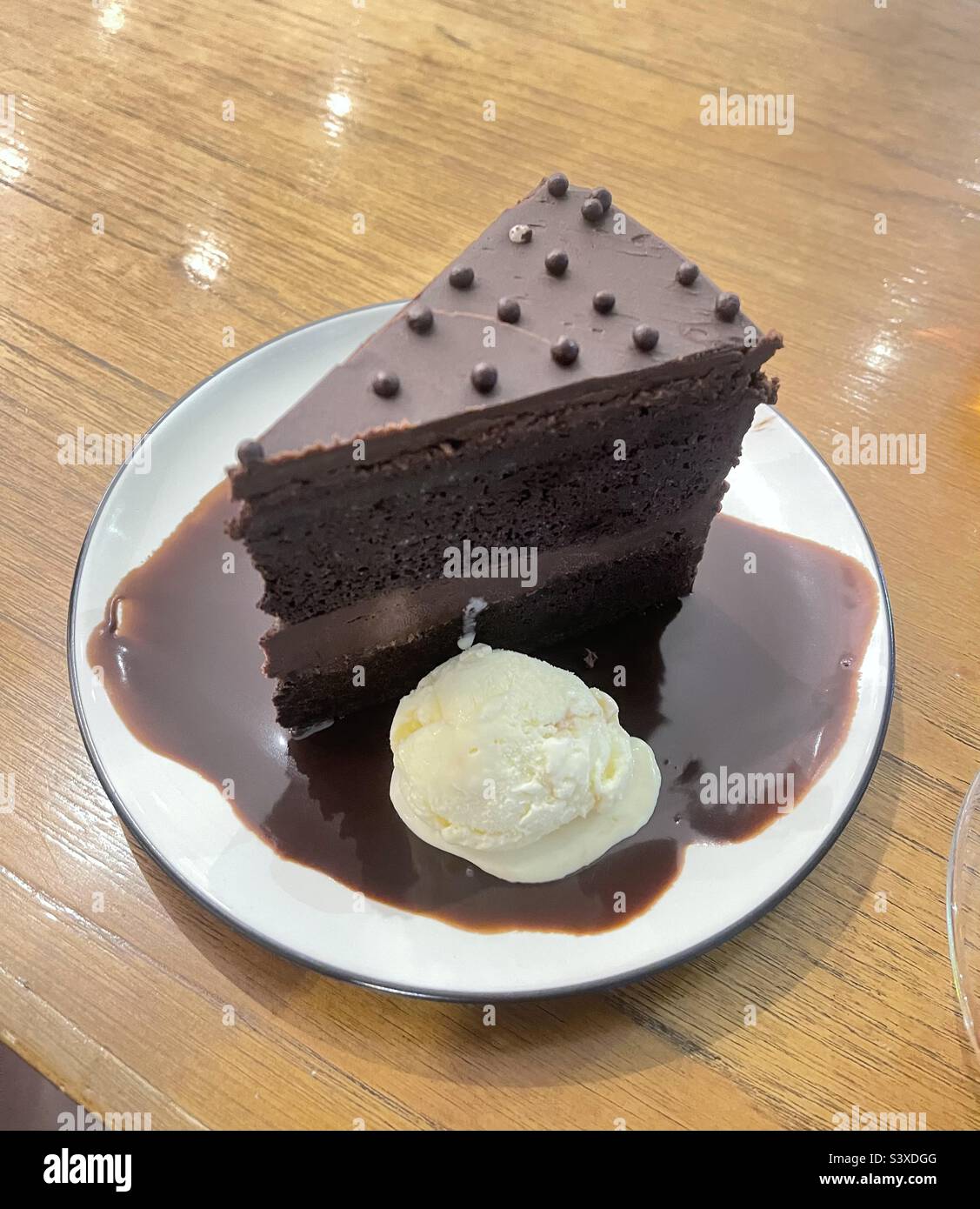 a slice of chocolate cake and a scoop of vanilla ice cream Stock Photo