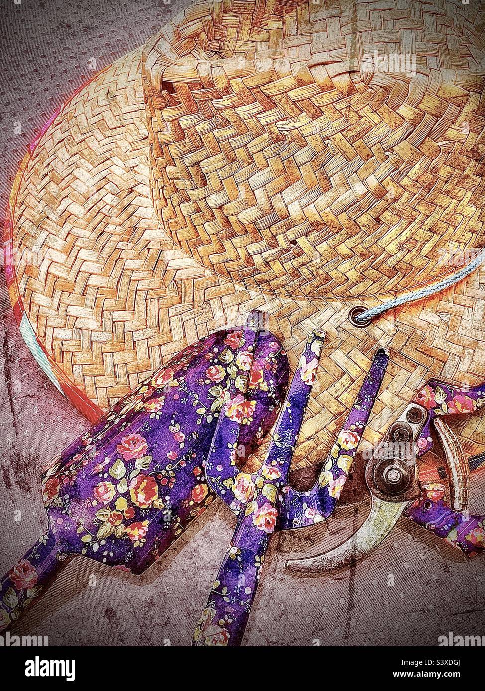 A gardening still life consisting of a colorful straw hat, and three flowery female garden tools, a garden claw/rake, a spade/ trowel and some pruning shears. Grunge effects are digitally added. - Smartphone Captured Stock Image