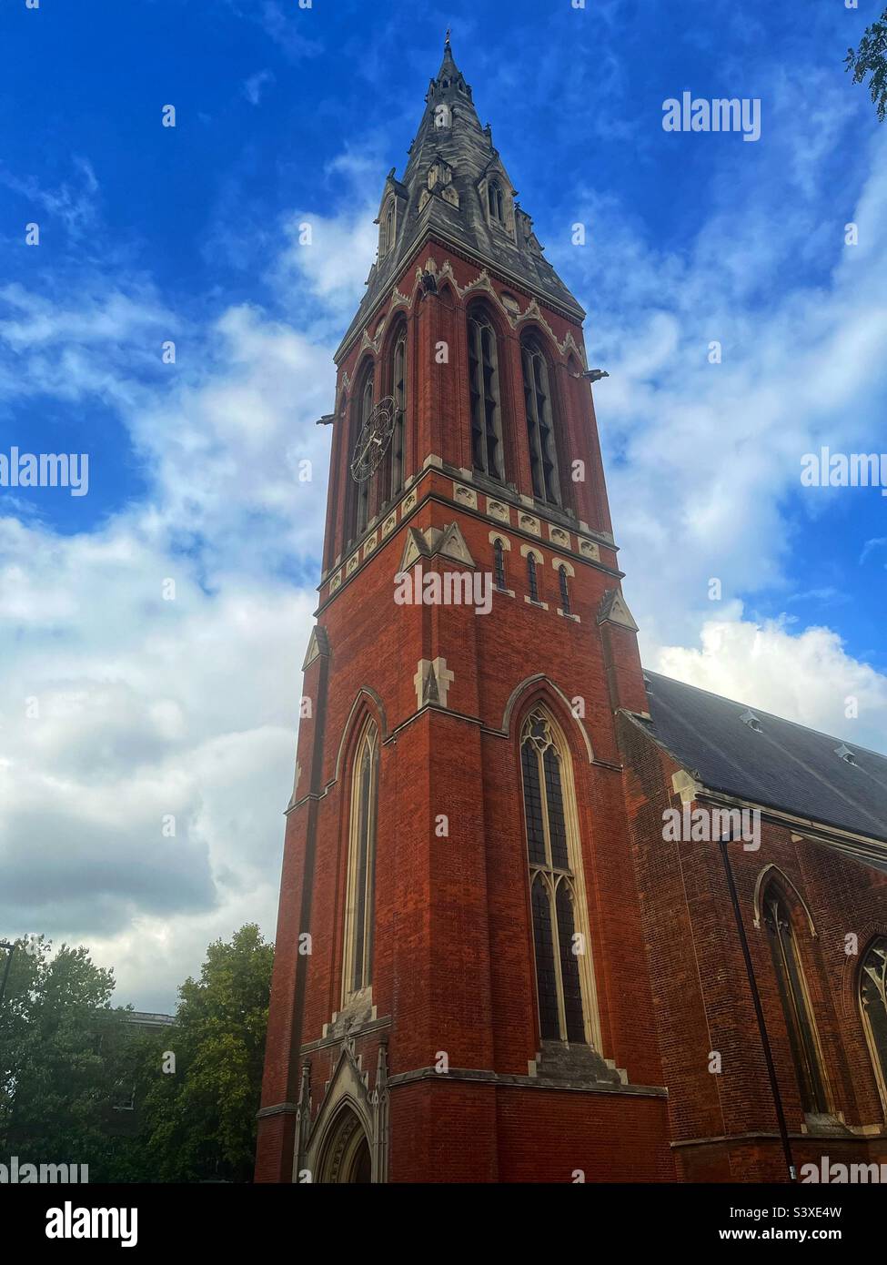 Spire and clock St John the Divine, Kennington, architecturally important building, Grade I Listed, South East London - Smartphone Captured Stock Image