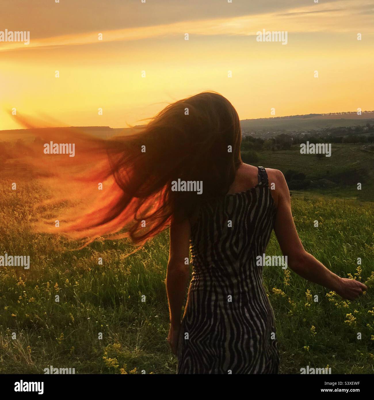 Wind in long hair of a young woman - Smartphone Captured Stock Image