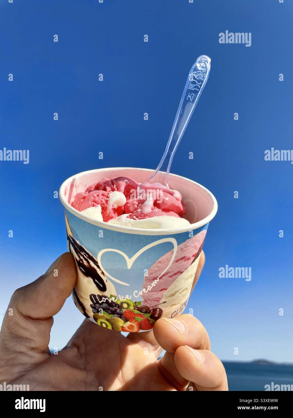 strawberry and vanilla ice cream agains clear blue sky - Smartphone Captured Stock Image