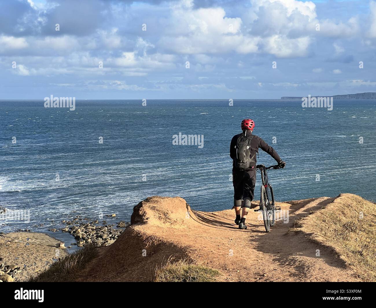 Cyclist reaches the end of the road on a clifftop - Smartphone Captured Stock Image