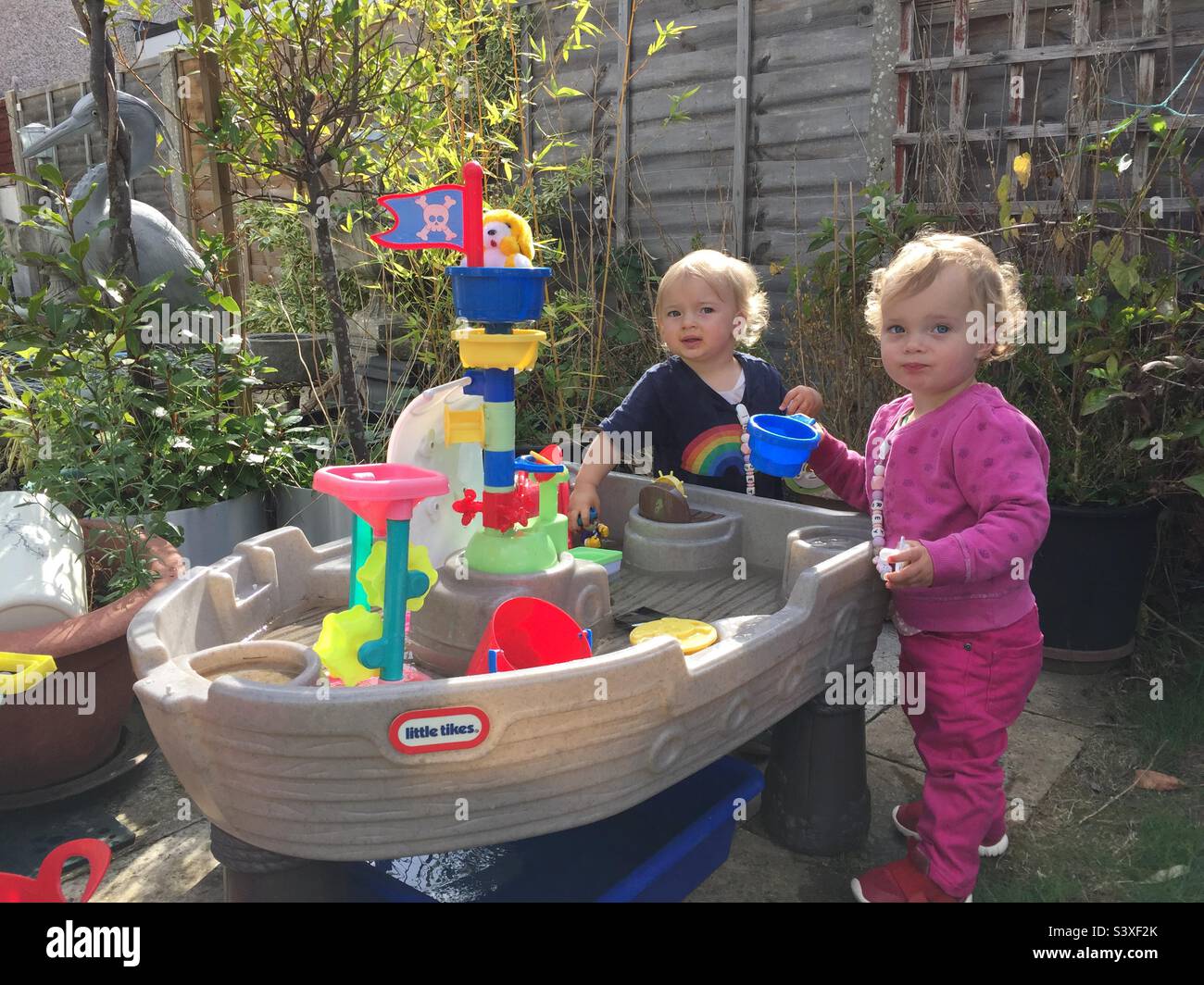 Twins playing at a water table - Smartphone Captured Stock Image