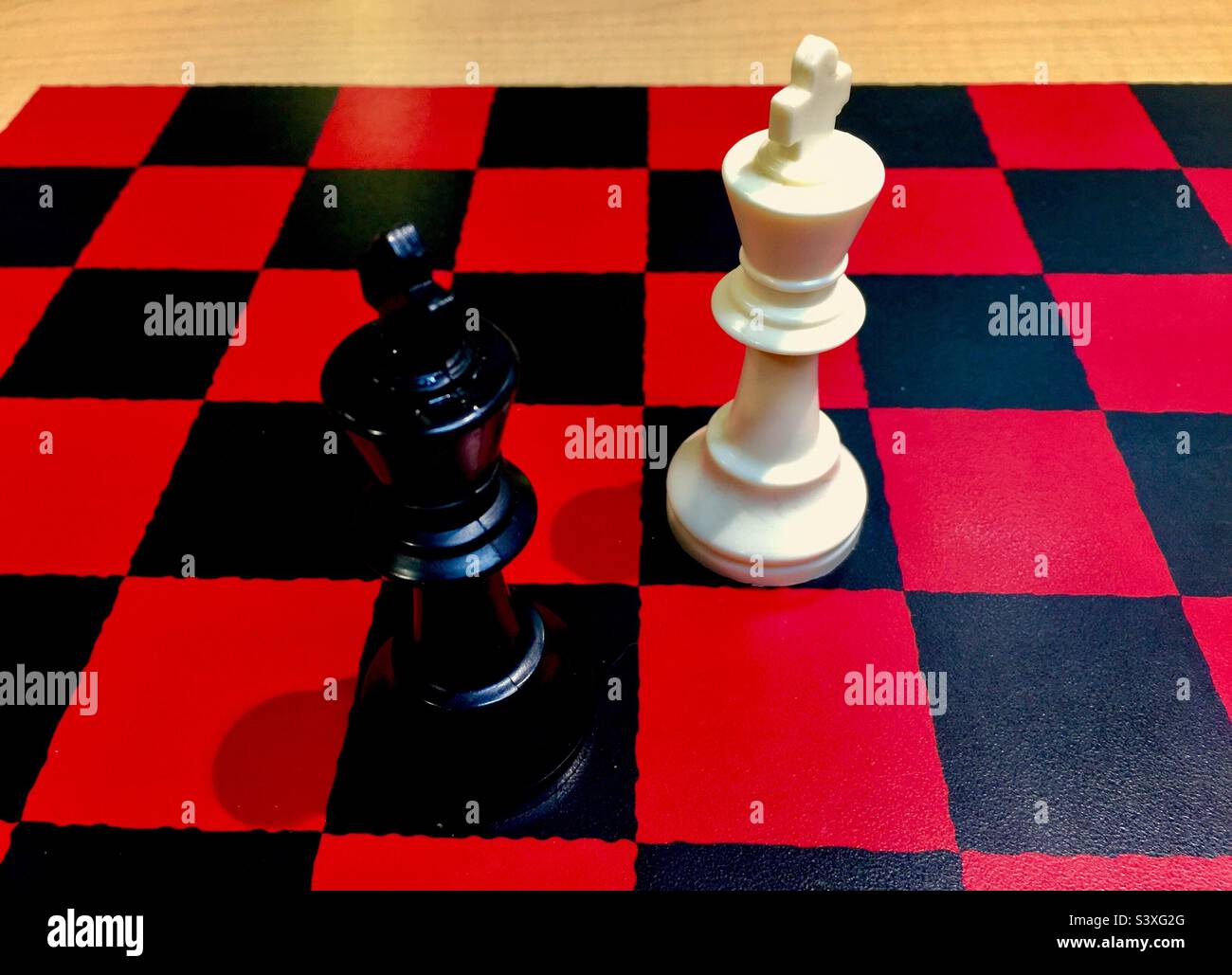 Two kings. Standing tall. Mighty. Antagonists. Rivals. Sworn enemies. The very top people. Symbolic. Red and black. - Smartphone Captured Stock Image