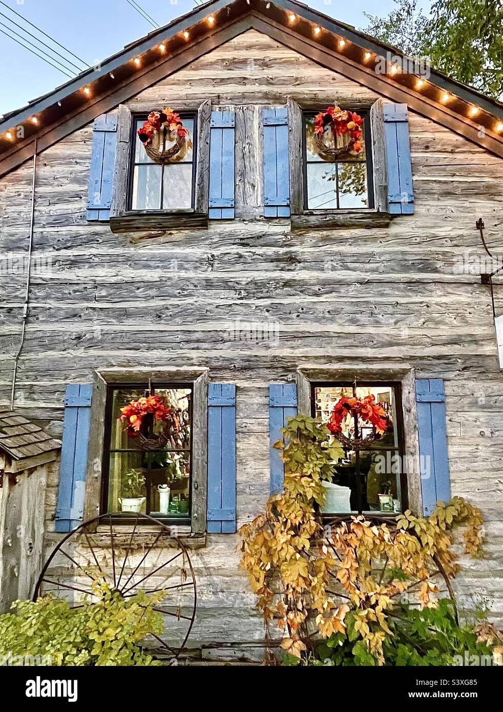 A rustic cabin building that is one of the many stores and shops within Gardner Village, a shopping and event venue. Here, this building is decorated for the upcoming Halloween season and WitchFest. - Smartphone Captured Stock Image