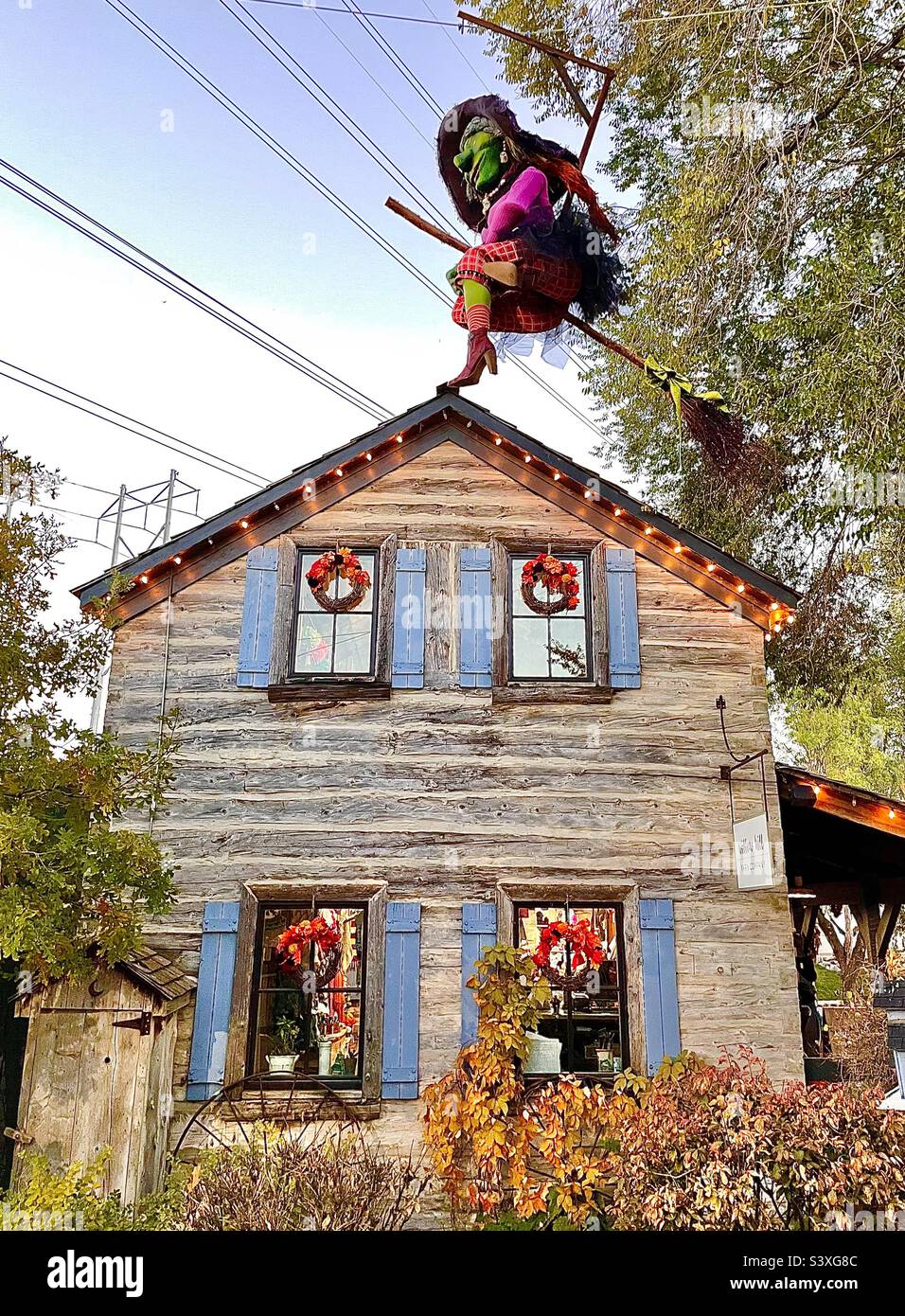 A rustic cabin building that is one of the many stores and shops within Gardner Village, a shopping and event venue. Here, this building is decorated for the upcoming Halloween season and WitchFest. - Smartphone Captured Stock Image