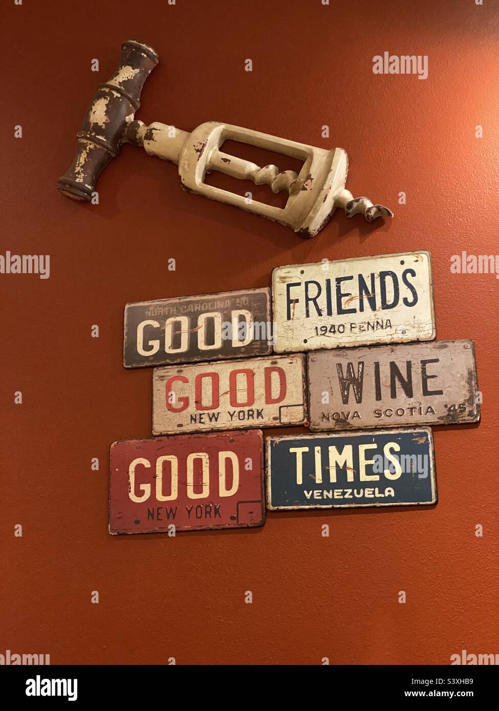 Restaurant wall decor with words, giant corkscrew and metal number