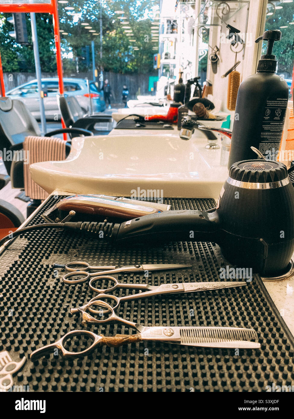 Barbers’ tools and sink laid out on a worktop. - Smartphone Captured Stock Image