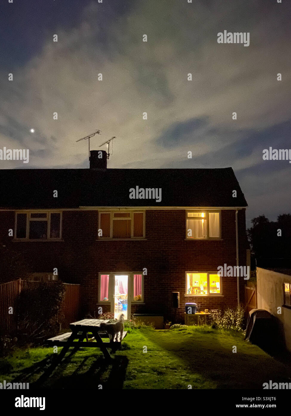 A shot of the back of a terrace house in the dark. - Smartphone Captured Stock Image