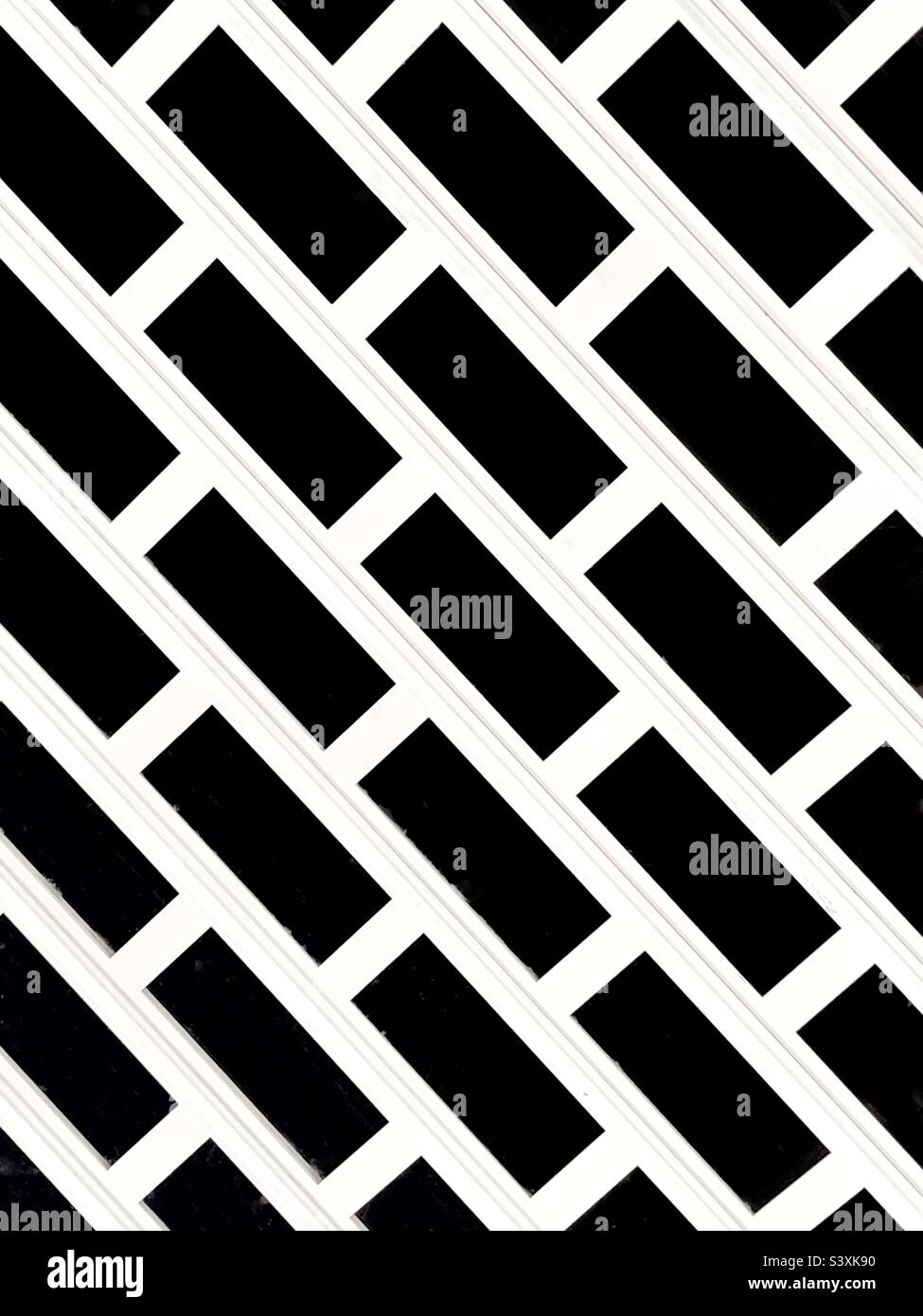 Pattern on a metal security grill over the entrance to a shop. No people. Stock Photo