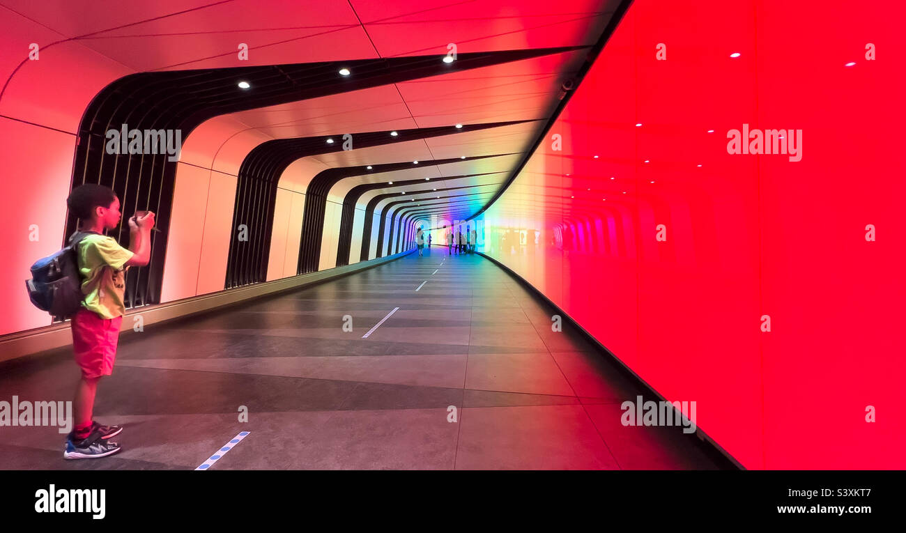 Boy taking photograph at London Kings Cross St Pancras train station, London, UK - July 2022 - Smartphone Captured Stock Image