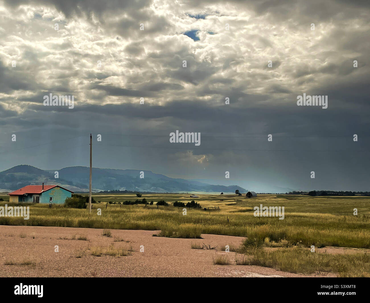 Wyoming big horn basin. Cabin on the left, moody sky, mountains on the