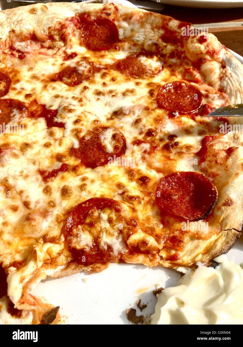 Eating pepperoni pizza Stock Photo Alamy