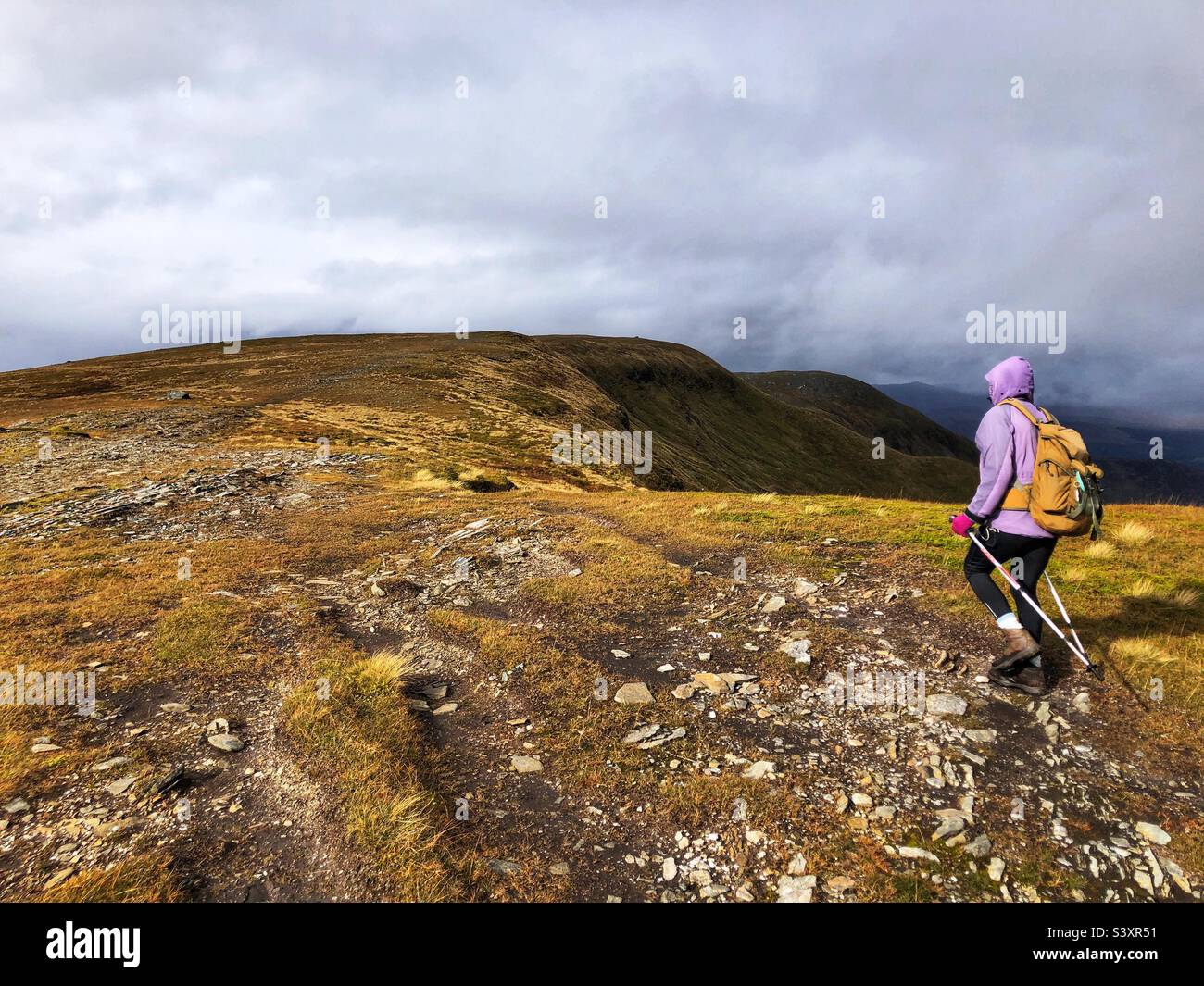 Female Walker on the ridge path of Munro Meall Buidhe, in the mist and low cloud, Glen Lyon, Scotland - Smartphone Captured Stock Image