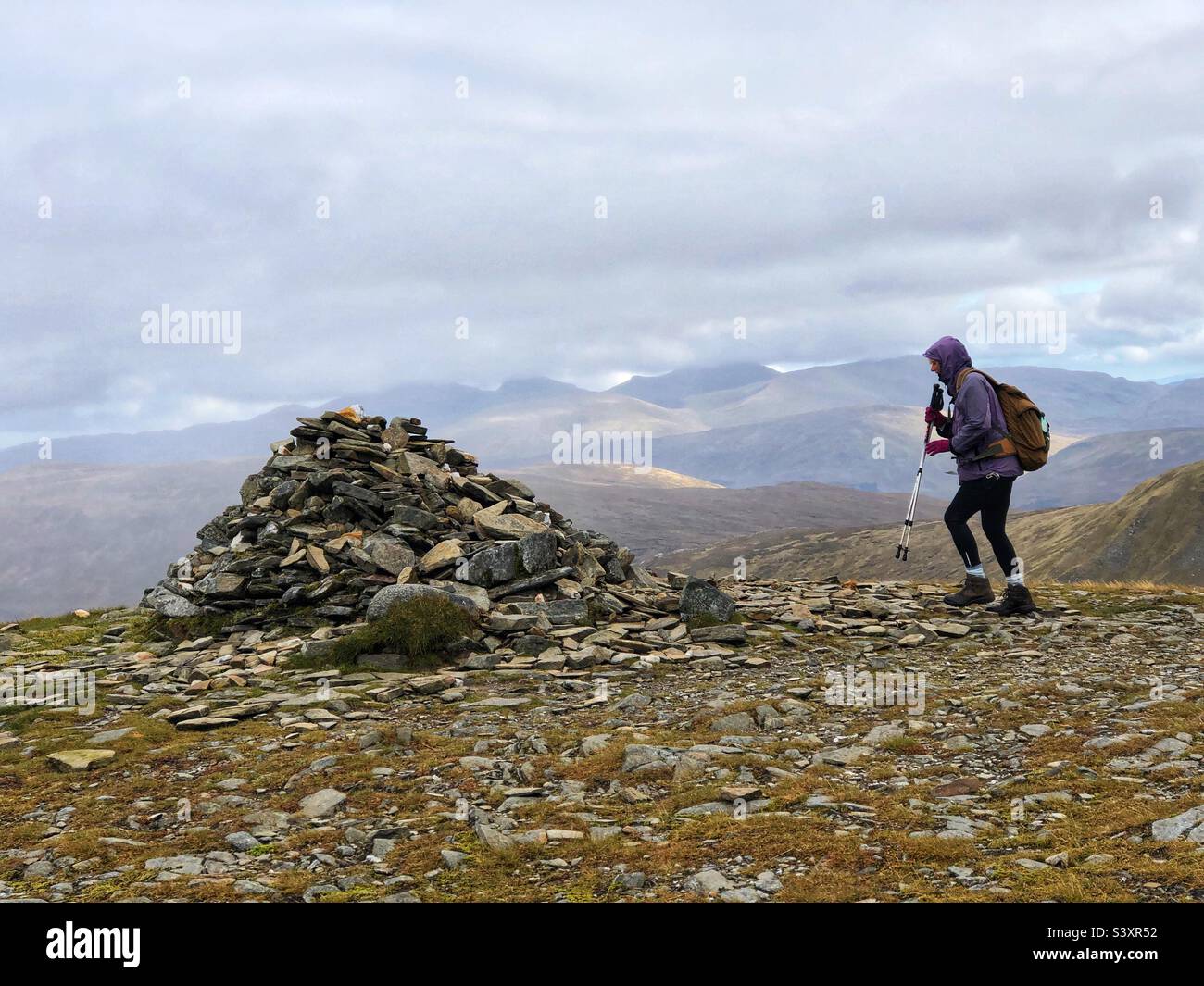 Female Walker on the ridge approaching the summit cairn of Munro Meall Buidhe, Glen Lyon, Scotland. - Smartphone Captured Stock Image