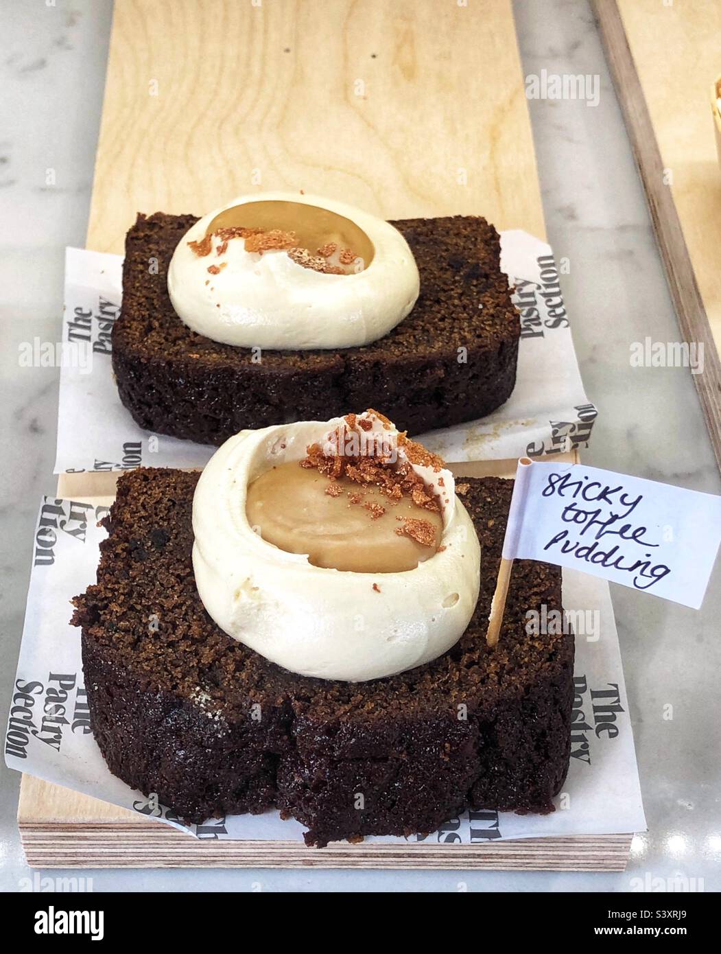 Cake Sticky Toffee Pudding in bakery window - Smartphone Captured Stock Image