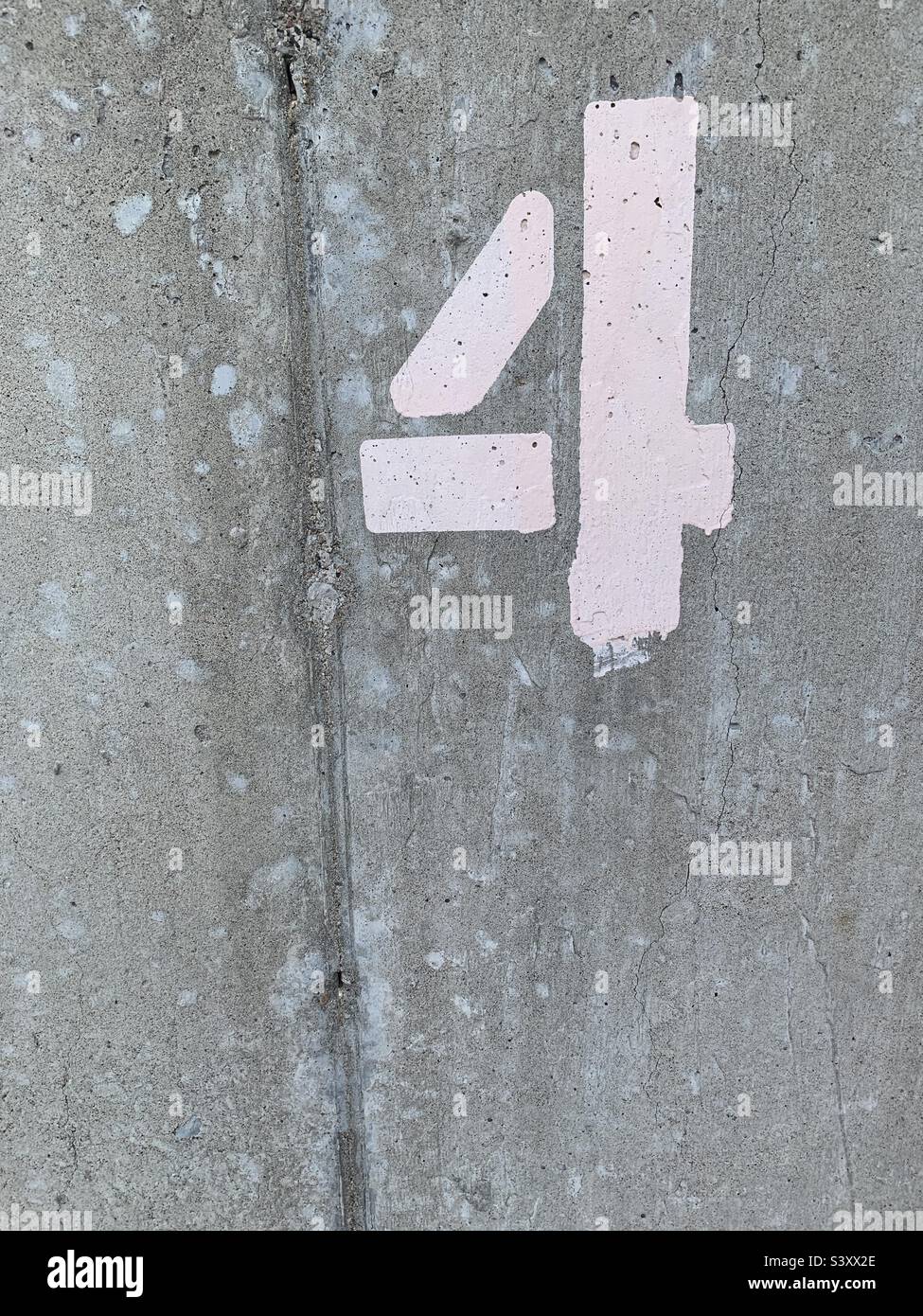 Gray cement background wall with number 4 stenciled on top right corner in white spray paint - Smartphone Captured Stock Image