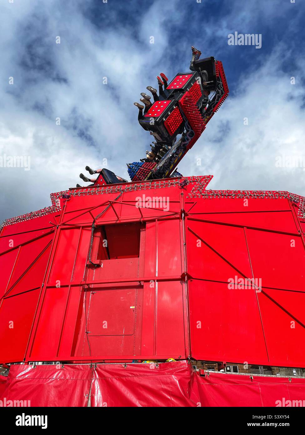 One of the fairground attractions at the Rood Fair, Whitesands, Dumfries, Scotland, with punters being whirled upside down. - Smartphone Captured Stock Image