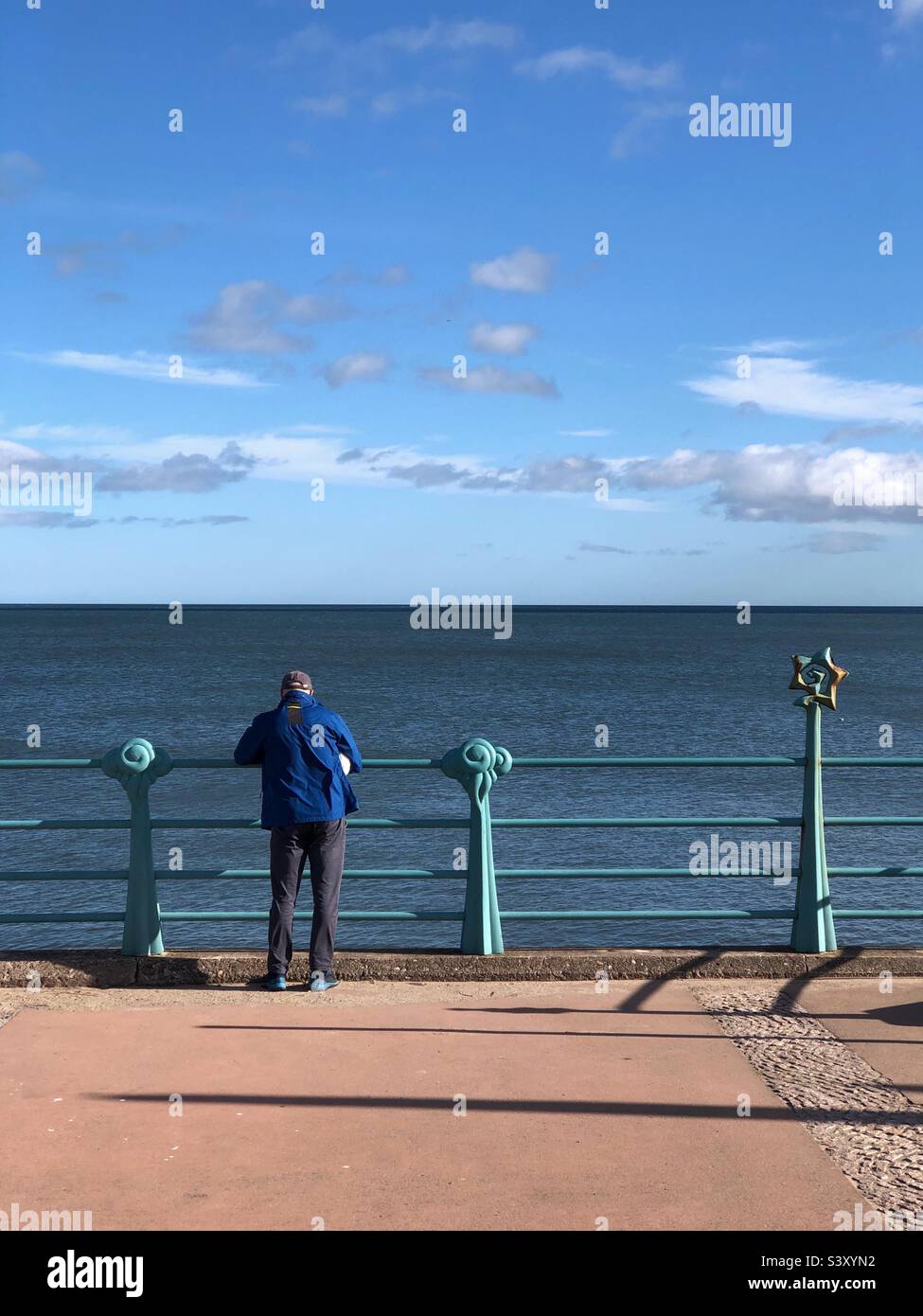 Man on The promenade looking out towards the North Sea at Montrose Scotland - Smartphone Captured Stock Image