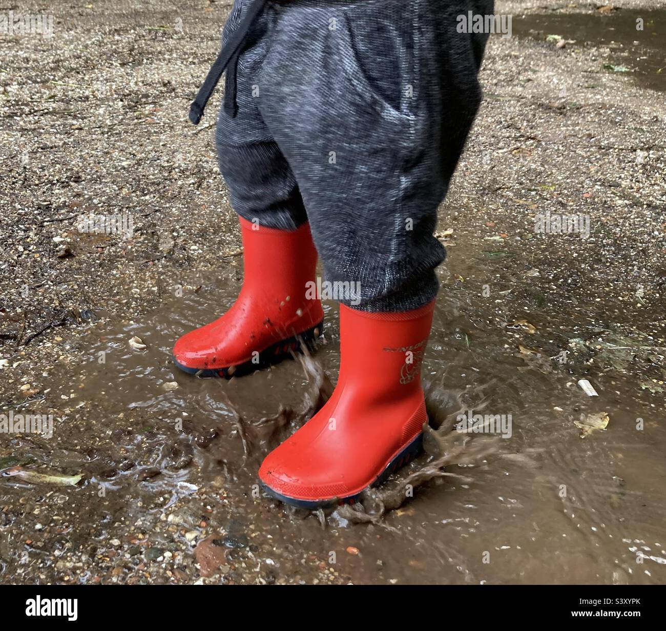 Red boots in a puddle Stock Photo