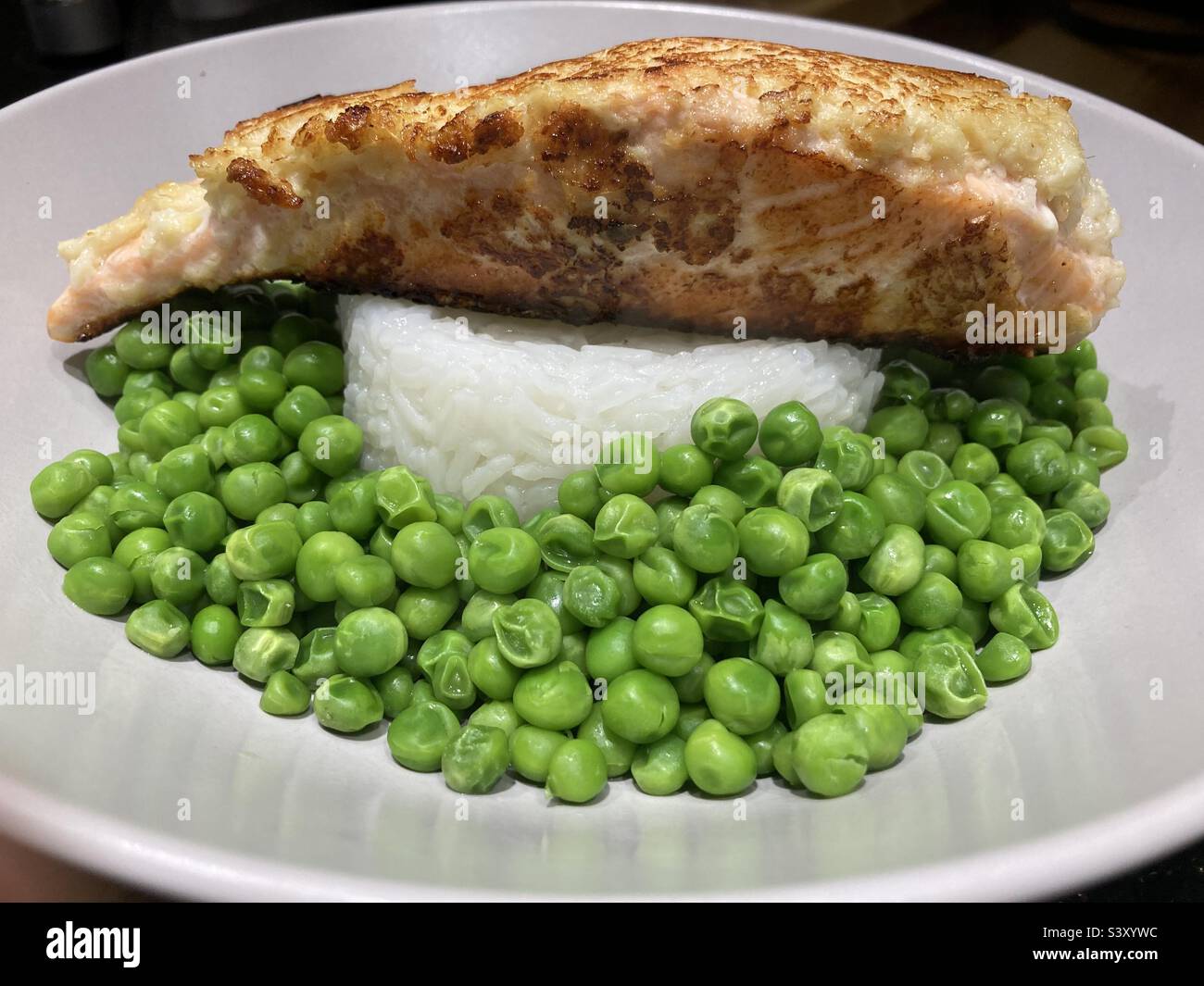 Garlic and ginger salmon with rice and peas Stock Photo Alamy