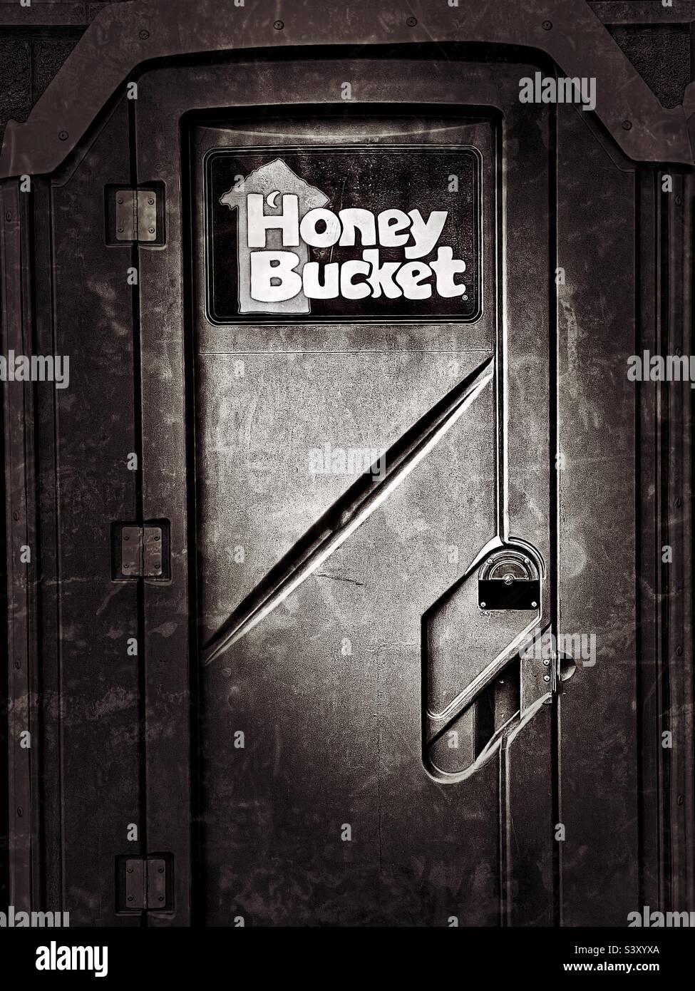 Public outhouses/toilets in a convenience store parking area in Utah, USA. A well known brand, commonly used for sites & events where needed in the region. Tongue-in-cheek name helps market the brand. - Smartphone Captured Stock Image