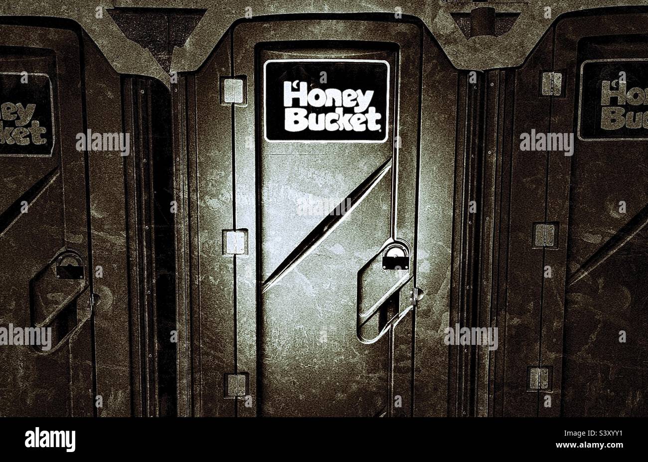 Public outhouses/toilets in a convenience store parking area in Utah, USA. A well known brand, commonly used for sites & events where needed in the region. Tongue-in-cheek name helps market the brand. - Smartphone Captured Stock Image