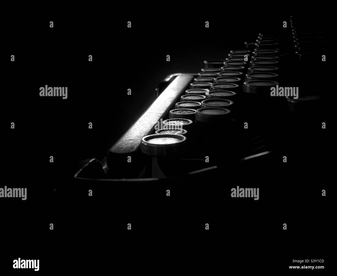 Moody image of a vintage typewriter in black and white - Smartphone Captured Stock Image