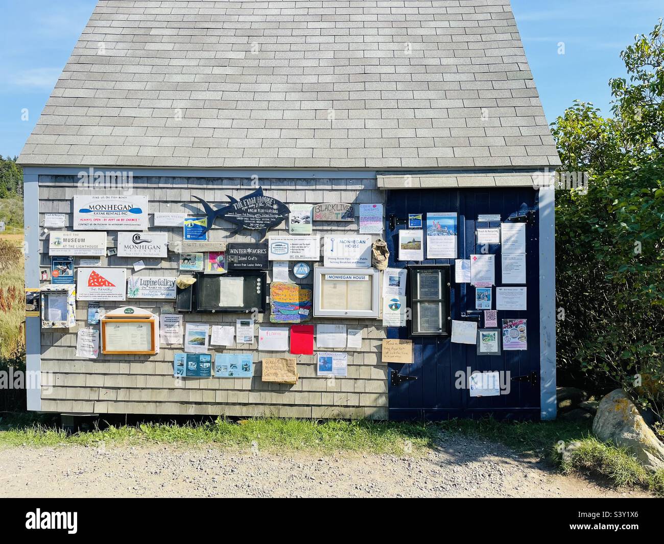 Town bulletin board at the side of a building on Main Street, Monhegan Island Stock Photo