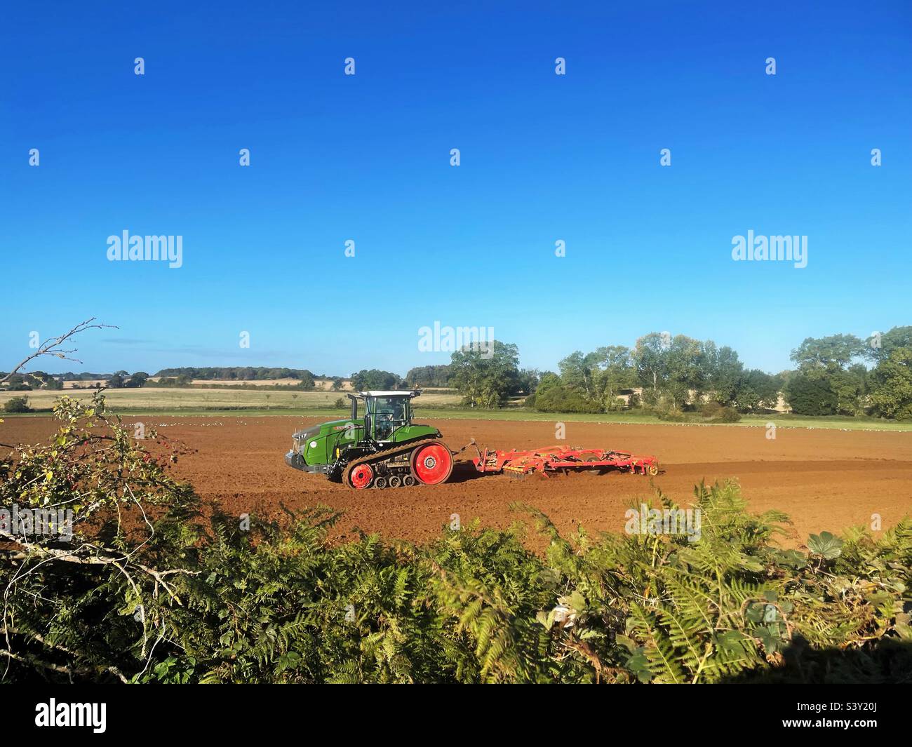 Tractor with discs cultivating land at Shottisham, Suffolk, England. - Smartphone Captured Stock Image