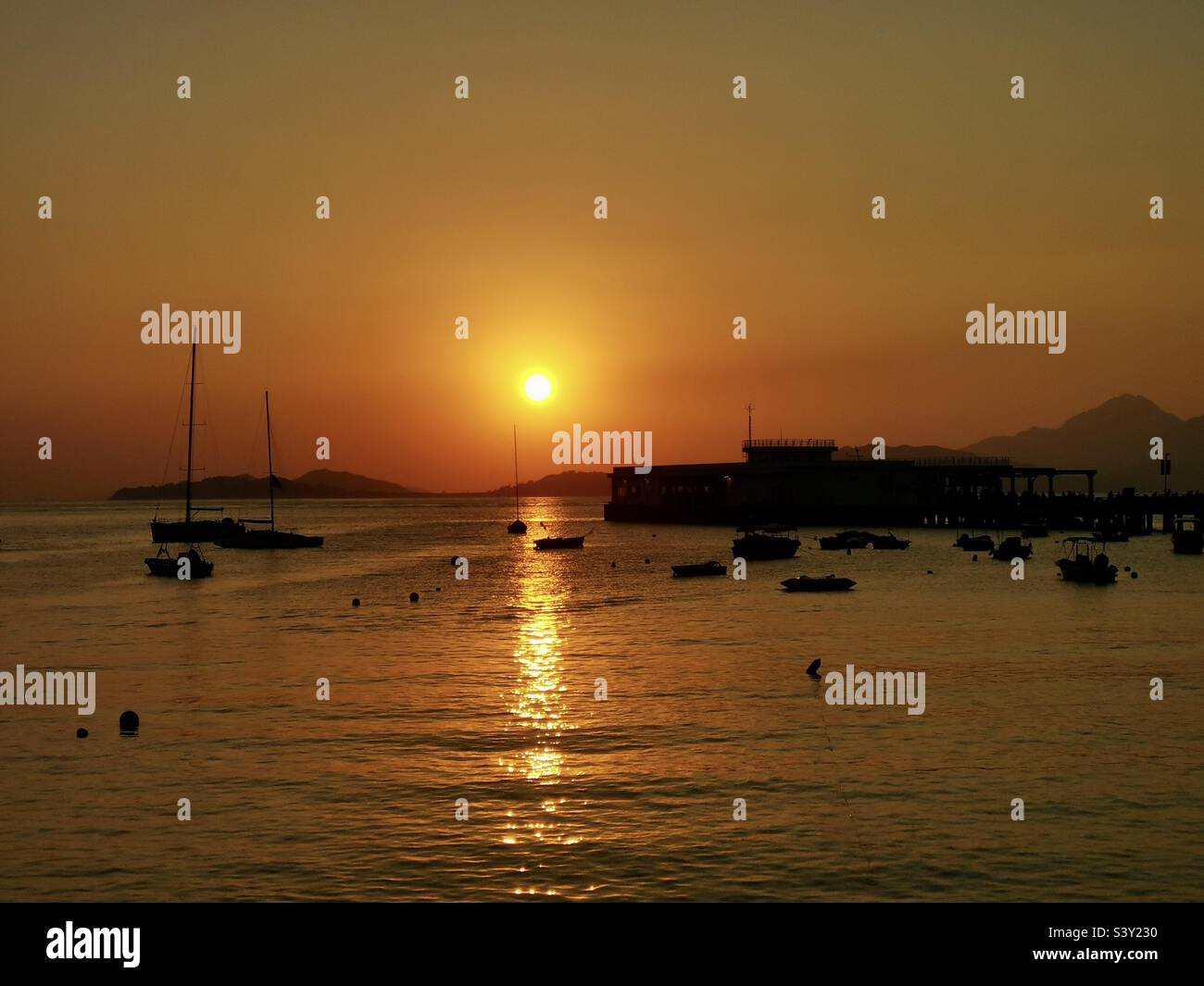 A beautiful sunset seen from Yung Shue Wan pier, Lamma island,Hong Kong. - Smartphone Captured Stock Image