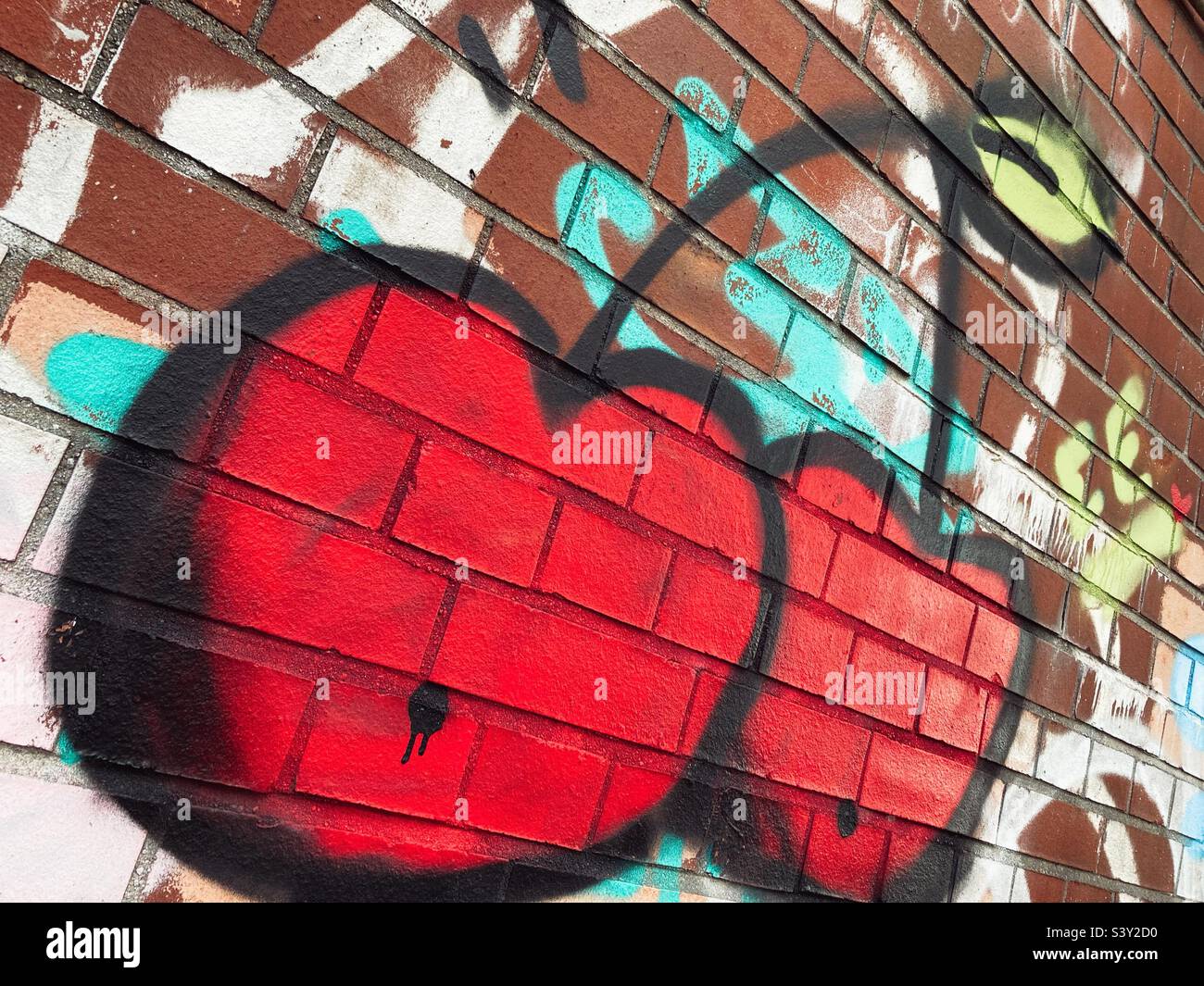 Graffiti of two cherries on a Wall in Berlin, Germany Stock Photo