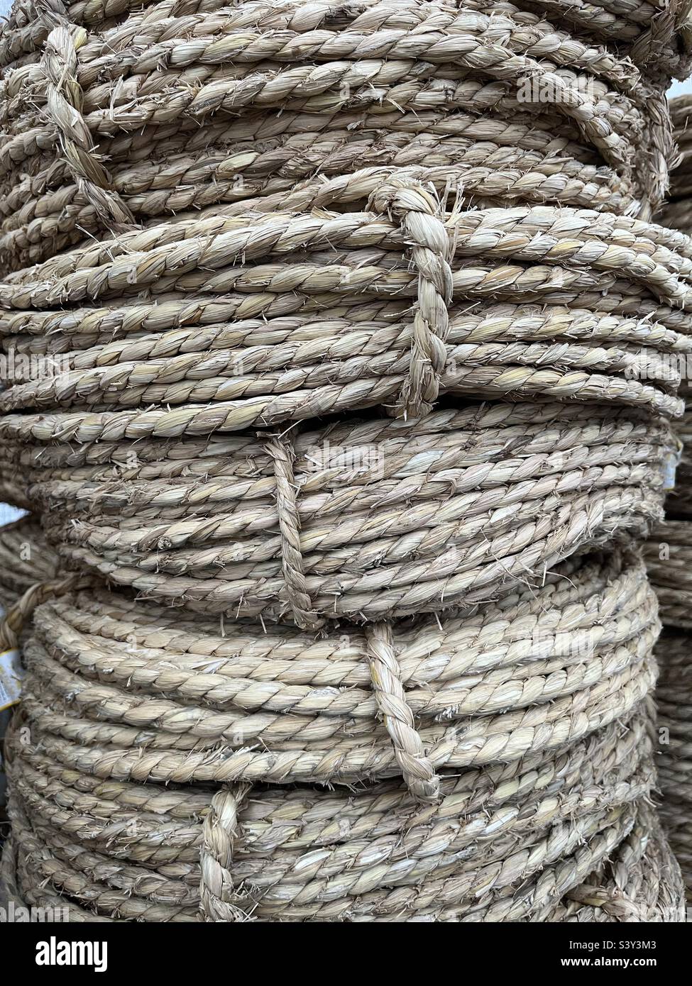 Stack of coils of brown rope made from natural fibre Stock Photo