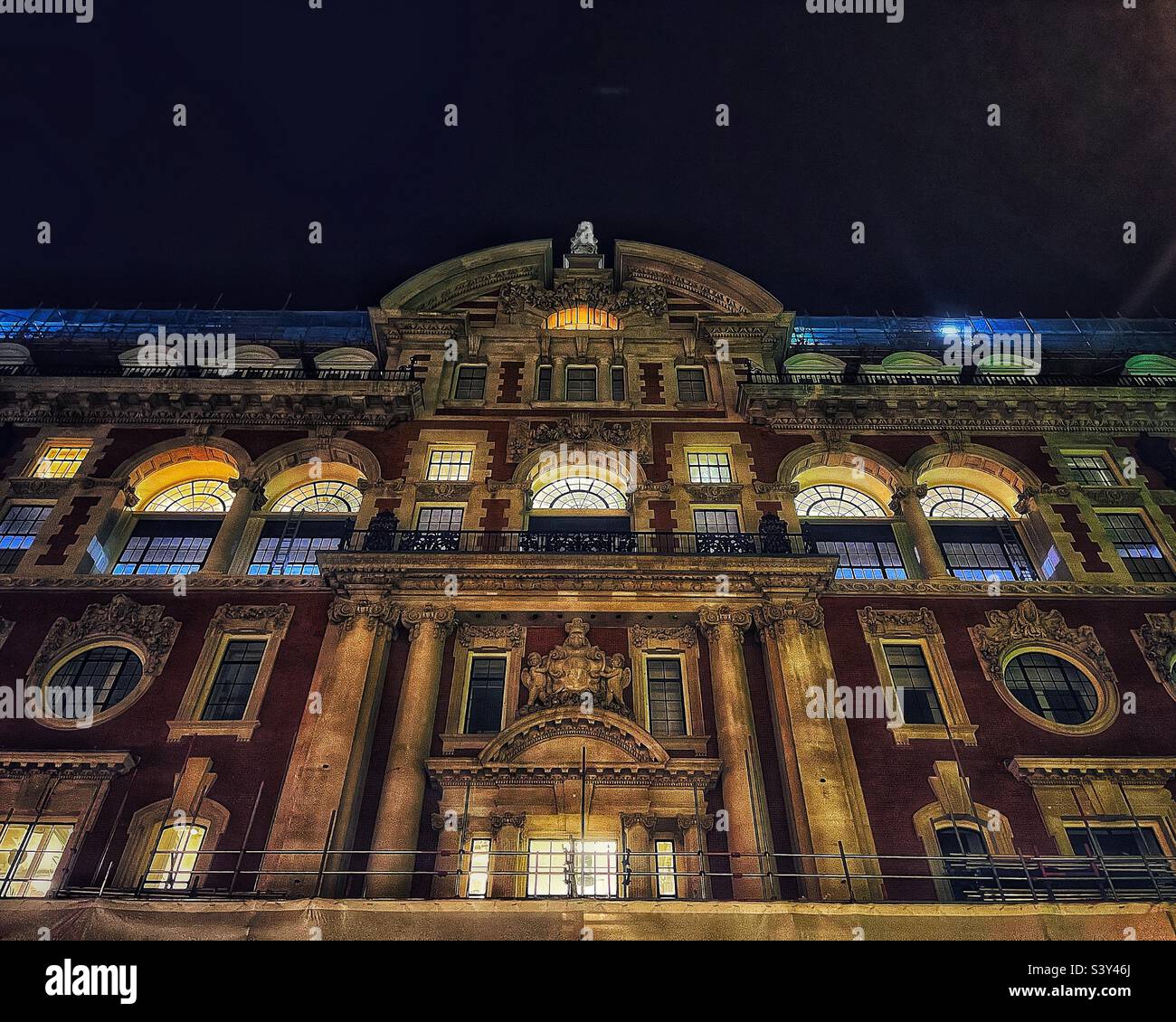 Former Waring and Gillow building 1905-6 using designs by R. Frank Atkinson on Oxford Street, London. Inspired by Hampton Court Palace in a Queen Anne style. Seen at night illuminated. - Smartphone Captured Stock Image