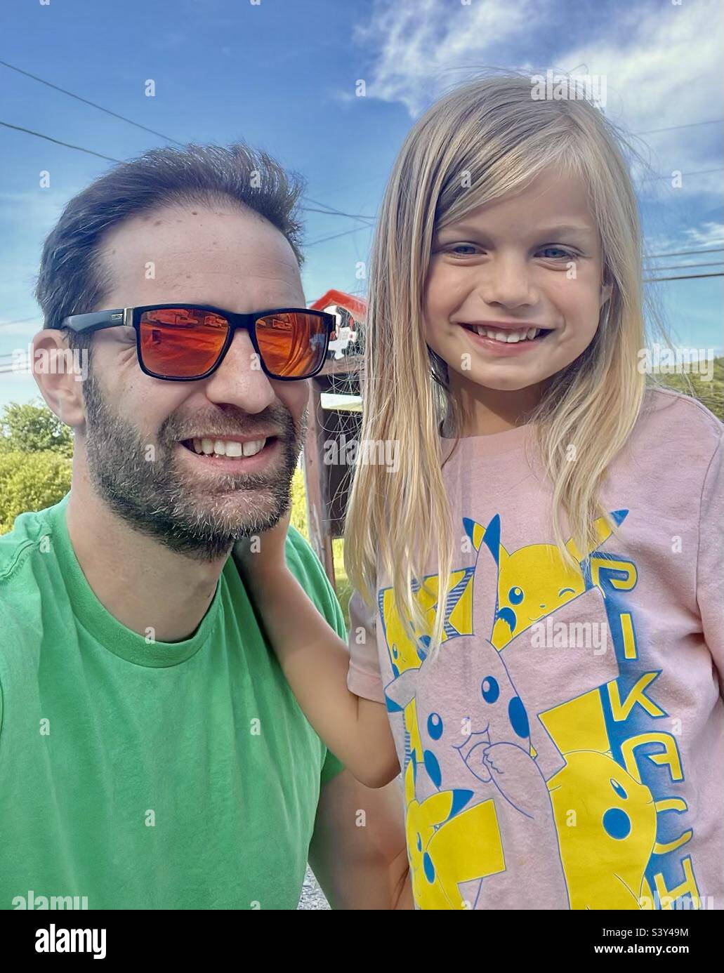 Man with orange sunglasses and daughter - Smartphone Captured Stock Image