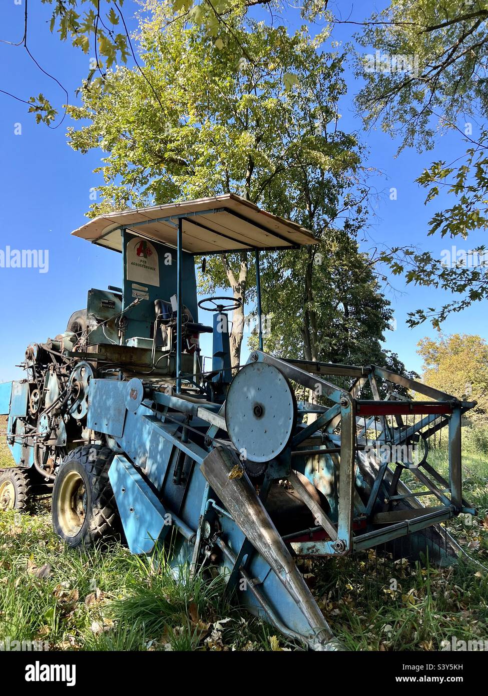Old wheat harvester.  Left in the field. Stock Photo