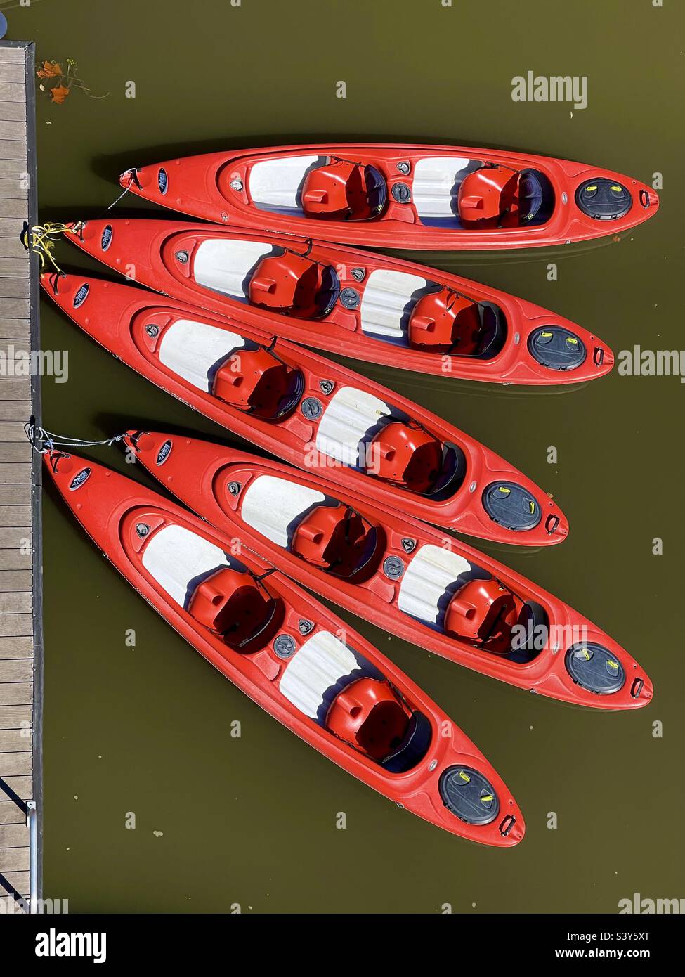 Five red kyaks tied up at a dock in the Gathering Place, Tulsa