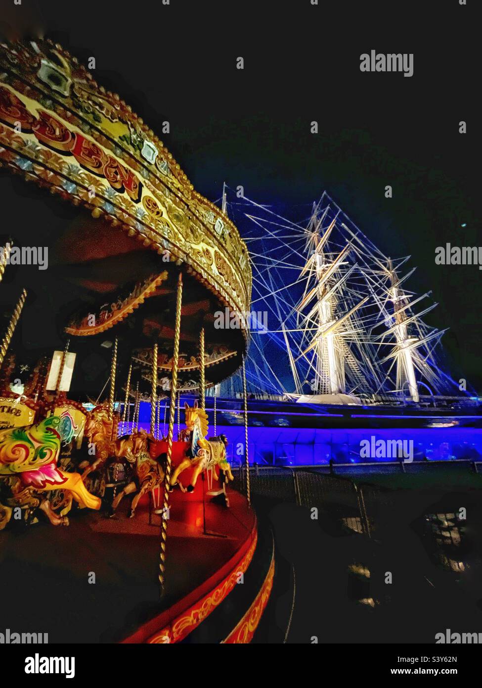 Carousel by the Cutty Sark old rigged ship, Greenwich, London. Tourists entertainment and attractions - Smartphone Captured Stock Image