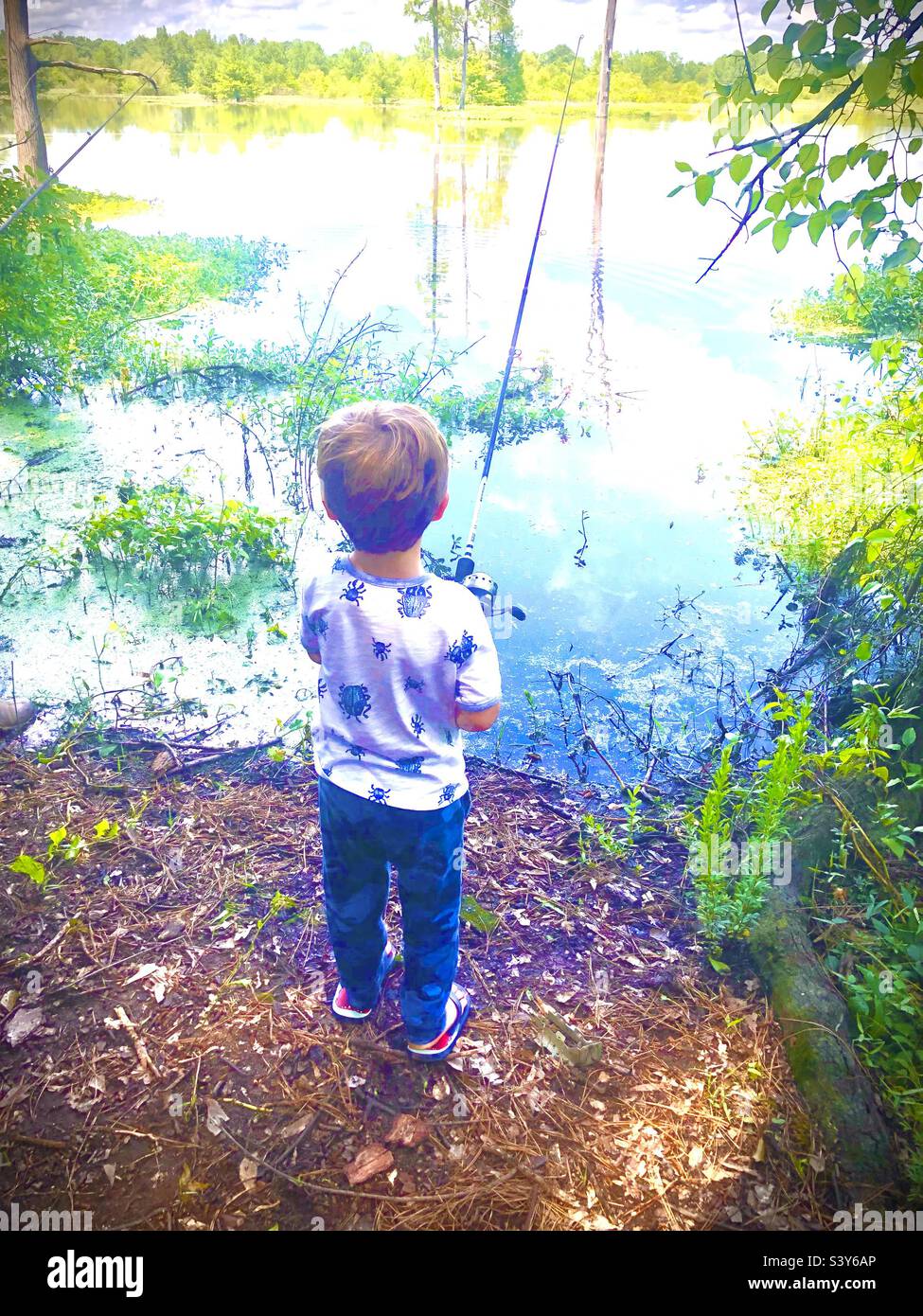 Small child fishing in backwoods lake Stock Photo