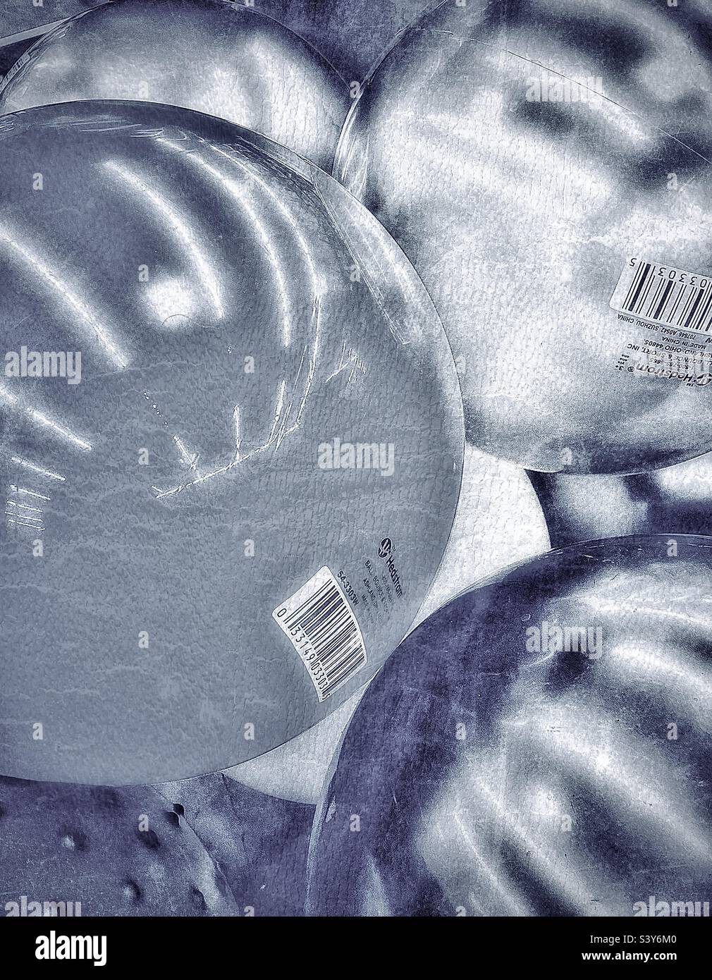 Multicolored bouncy rubber balls in a toy dept. bin at a local retailer in Utah, USA. Image has been desaturated so the focus can be on the abstract of the light, shadow, tones, shapes, and textures. - Smartphone Captured Stock Image