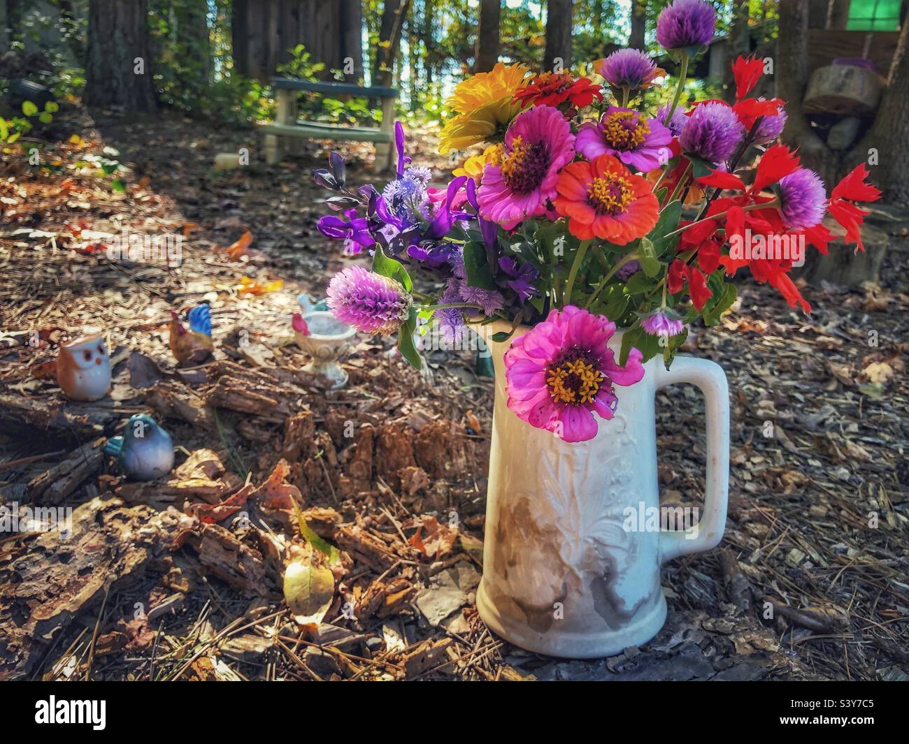Garden flower bouquet with ceramic animals - Smartphone Captured Stock Image