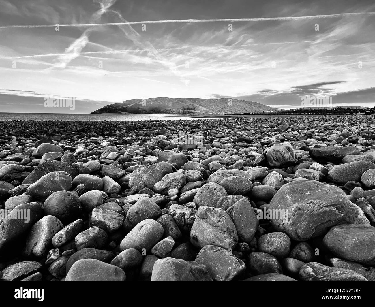 Dramatic and moody shot of Porlock bay with close up of pebbles Stock Photo