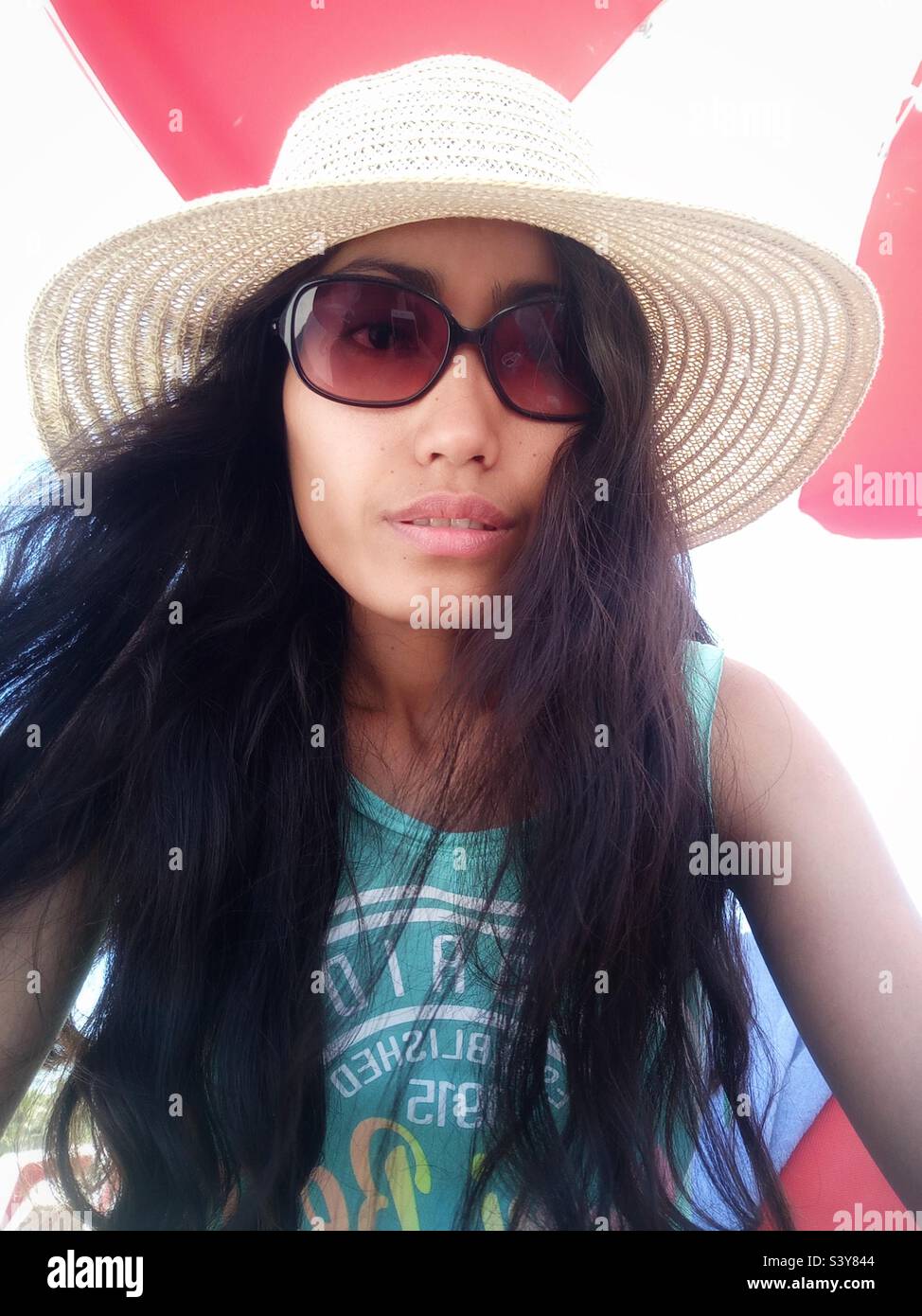 A woman wearing a hat and with a long hair - Smartphone Captured Stock Image