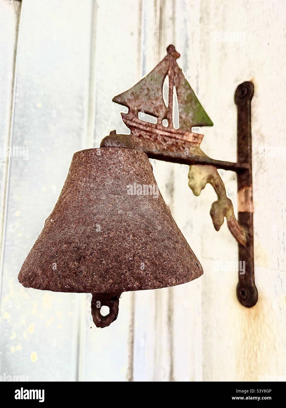 Old bell with boat for a door bell with lovely patina Stock Photo