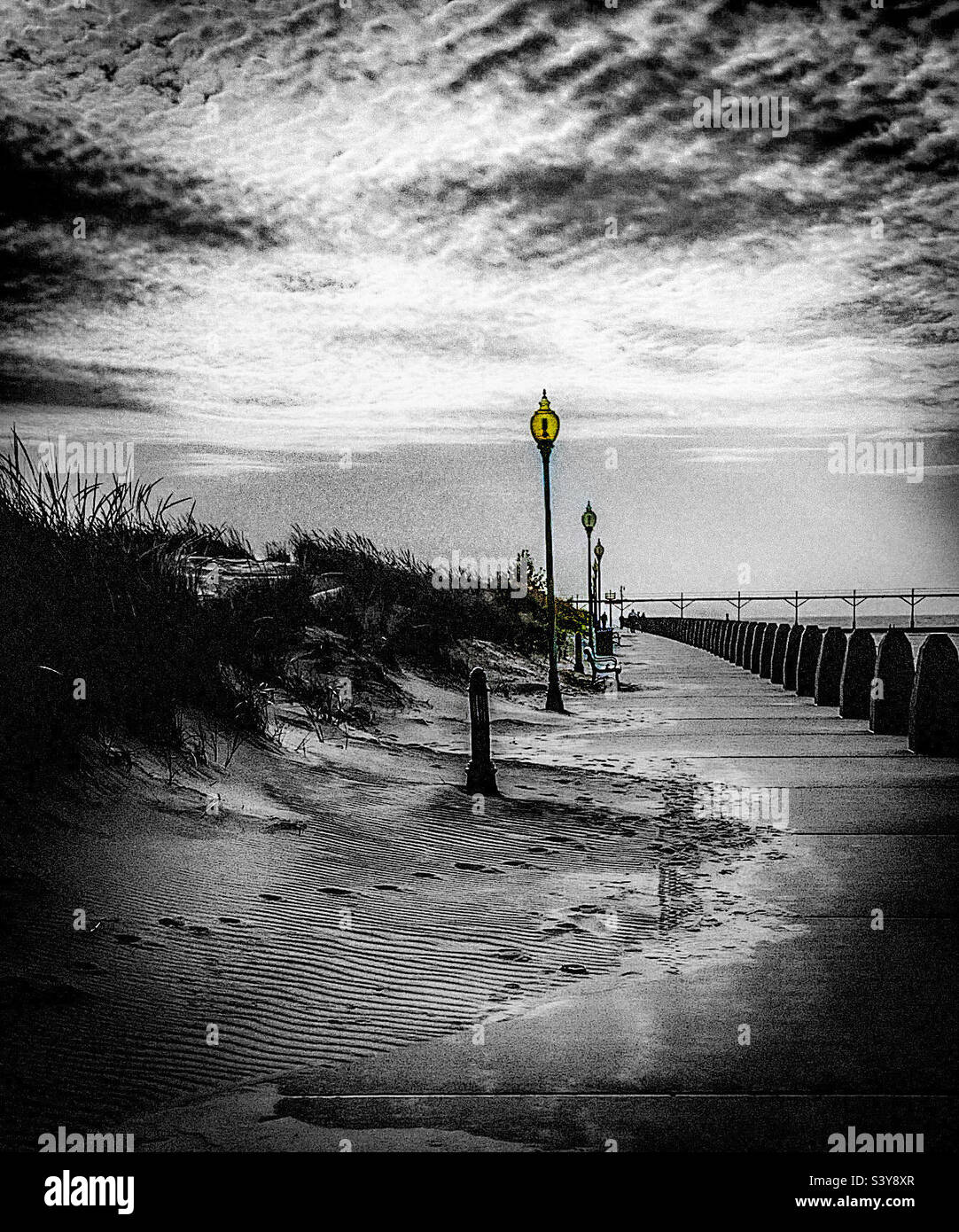 Black and white with yellow light photo of sidewalk at Washington Beach