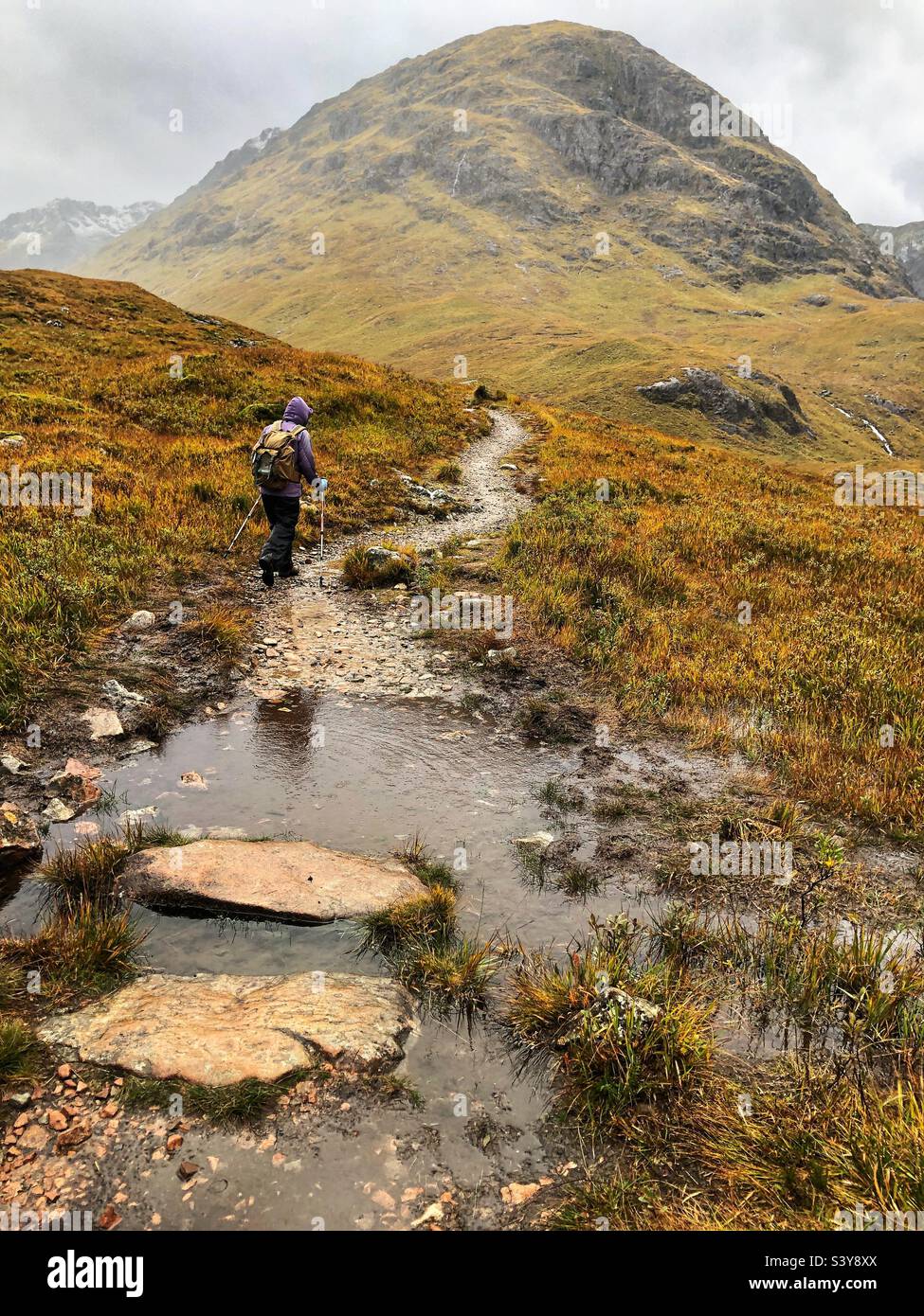 Female Walker on the path and slopes of Munro Buachaille Etive Beag, Glencoe, Scotland - Smartphone Captured Stock Image