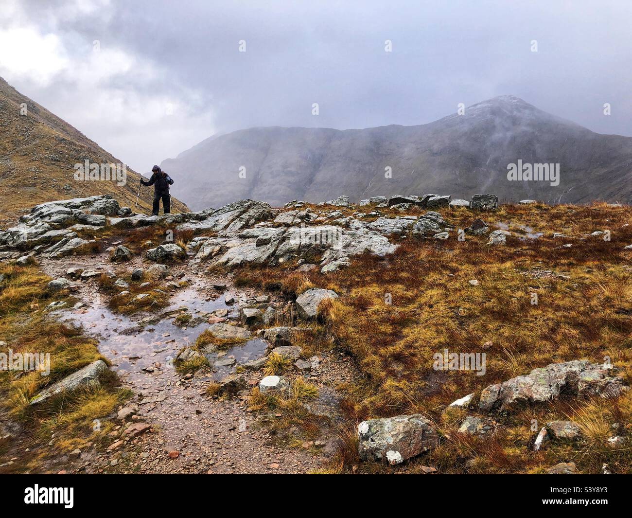 Female Walker on the path and slopes of Munro Buachaille Etive Beag, Glencoe, Scotland - Smartphone Captured Stock Image